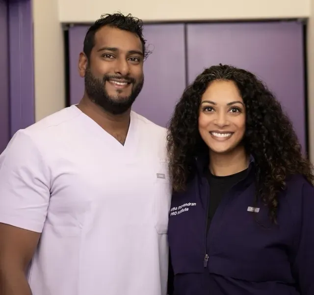 Dr. Gayan Poovendran and Colleague Healthcare Professionals Representing Excellence in Care – pro institute Smiling male and female healthcare providers wearing branded uniforms, standing side by side in a professional clinical setting – pro institute